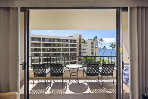 a balcony with chairs and a table on a balcony at SUGAR BEACH RESORT, #409 condo in Kihei