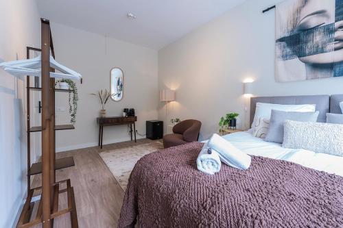 a bedroom with a bed and a chair in it at Nature Budget Bedroom Near University Tilburg in Tilburg