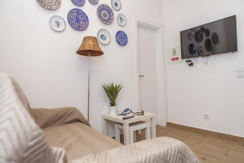 a living room with blue and white plates on the wall at B54 - Casa Azul in Burgau in Budens