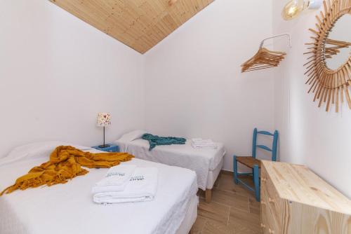 a room with two beds and a wooden table at B54 - Casa Azul in Burgau in Budens