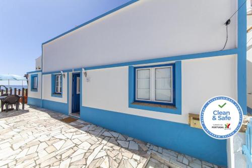 a blue and white building with a sign that says clean and safe at B54 - Casa Azul in Burgau in Budens