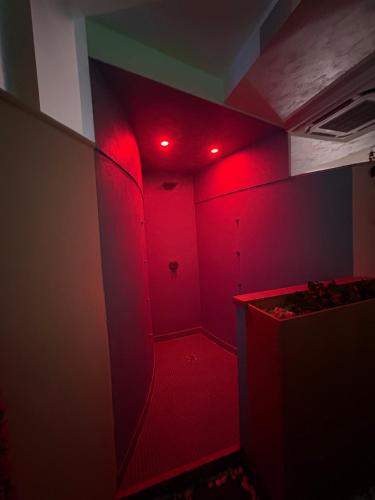 a room with red lights on the wall at Onepta Retreat in Reggio Calabria
