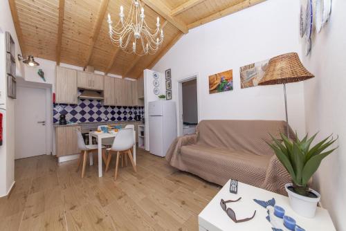 a living room with a couch and a table at B54 - Casa Azul in Burgau in Budens