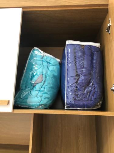 two pillows are sitting on a shelf at Germinado familiar 5 in São Francisco do Sul