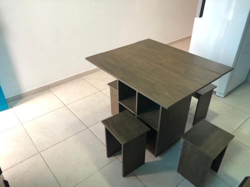 a wooden table with two benches next to a table at Germinado familiar 5 in São Francisco do Sul
