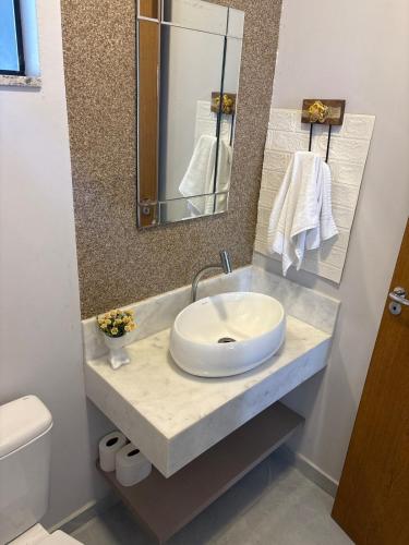 a bathroom with a sink and a mirror at Casa Joinville in Joinville