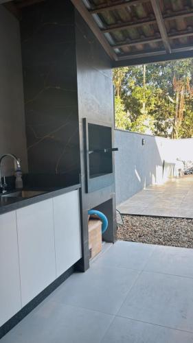 a kitchen with a sink and a counter top at Casa Joinville in Joinville