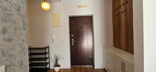 a hallway with a brown door in a room at Modern City 1BR in the best location Ferizaj in Ferizaj