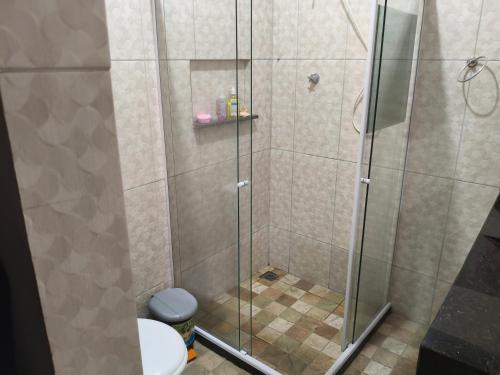 a shower with a glass door in a bathroom at Casa Avance RH Aconchego in Camaçari