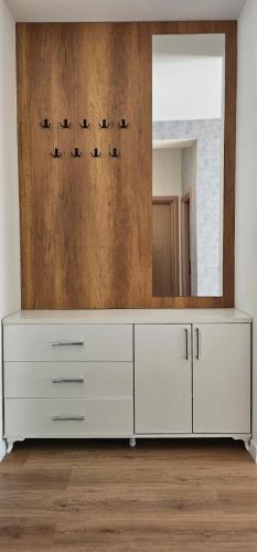 a white dresser in a room with a mirror at Modern City 1BR in the best location Ferizaj in Ferizaj