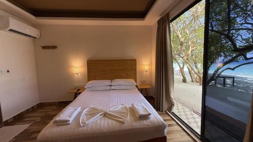 a bedroom with a bed with bows on it at Belmar Beach in Bodufolhudhoo