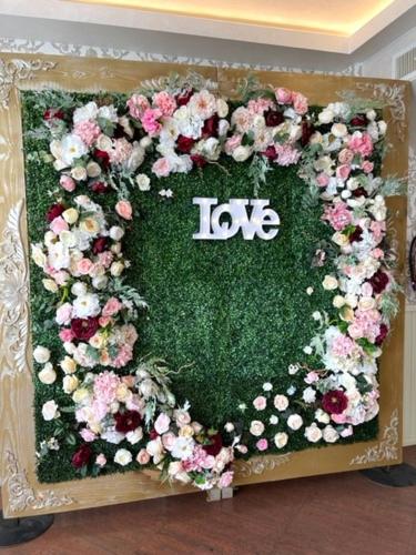 a heart shaped wreath with flowers on it at Pensiunea Bianca in Botoşani