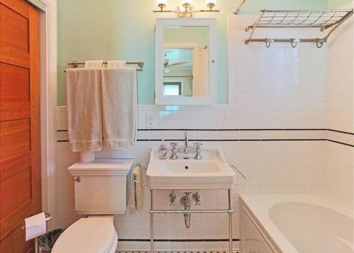 a bathroom with a toilet and a sink and a tub at Beach Condo With Heated Pool, Coral Resort A1 in Clearwater Beach