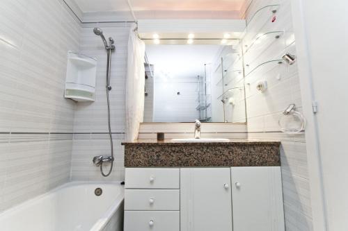 a bathroom with a tub and a sink and a shower at Magica Planetcostadorada in Cambrils