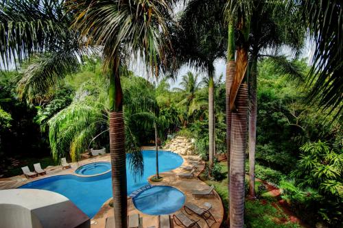 a resort with two pools and palm trees at Palmar del Sol by Riviera Maya Suites in Playa del Carmen