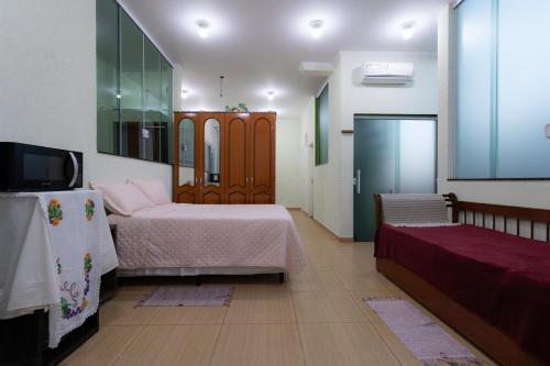 Ένα ή περισσότερα κρεβάτια σε δωμάτιο στο Loft dos Beija Flores