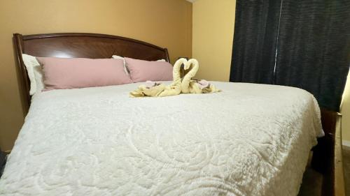 a stuffed animal sitting on top of a bed at The Poolside Escape Near Beaches in Port Saint Lucie