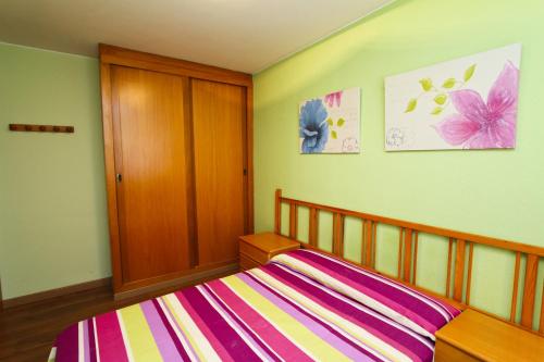 a bedroom with a bed with a striped blanket at Mexico Planetcostadorada in Vilafortuny