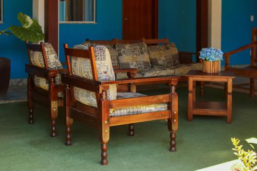 a living room with a couch and two chairs and a table at Pousada Vilela in São Mateus