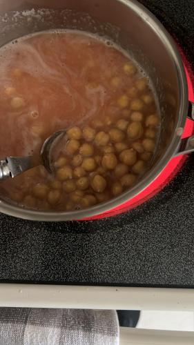 a pot of food with beans on a stove at Dept familiar a pasos de la playa con auto check in in Crucita