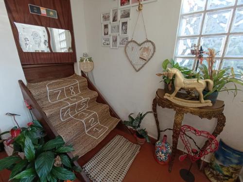 a room with a staircase with a horse on a table at Orion Guesthouse Telhado in Fundão