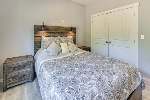 a bedroom with a large bed and a wooden headboard at 2 Mi to Marina and Lake Cumberland! Newly Built Home in Somerset
