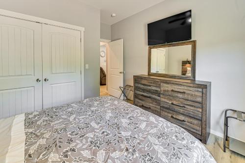 a bedroom with a bed and a dresser with a mirror at 2 Mi to Marina and Lake Cumberland! Newly Built Home in Somerset