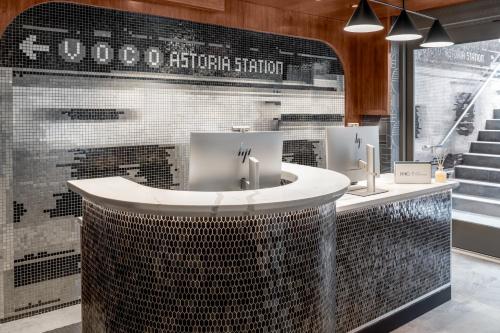 a bathroom with two sinks and a counter at voco Astoria by IHG in New York