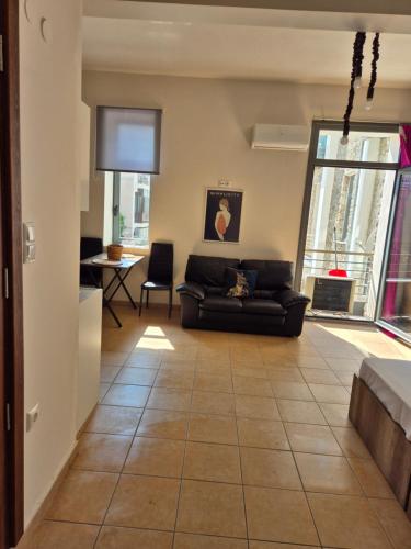 a living room with a couch and a table at 365 studios - Close to the beach in Kavala