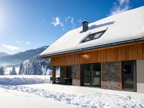 a house with snow on the roof at Mountain Vista in Sankt Lorenzen ob Murau