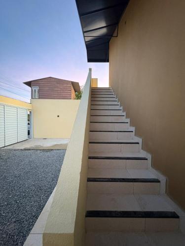 a staircase leading up to a house with a building at Pousada Brisa Rio in Aracaju