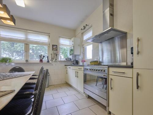 a large kitchen with white cabinets and a stove at t Achterhoes in Diepenheim