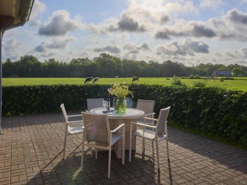 a table and chairs with a field in the background at t Achterhoes in Diepenheim