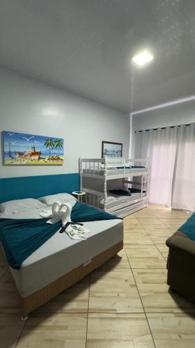 a bedroom with a bed and a desk in it at Pousada Vista Horizonte in Penha