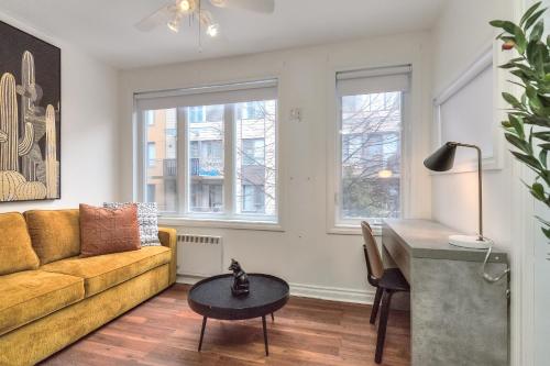 a living room with a couch and a table at Fox Aparthotel Palais Des Congres V in Montréal