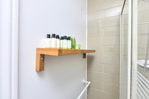 a bathroom with a wooden shelf on the wall at Fox Aparthotel Palais Des Congres V in Montréal