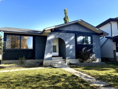 a house with a blue house at Falcon Escape in Calgary