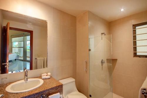 a bathroom with a sink toilet and a shower at Palmar del Sol by Riviera Maya Suites in Playa del Carmen
