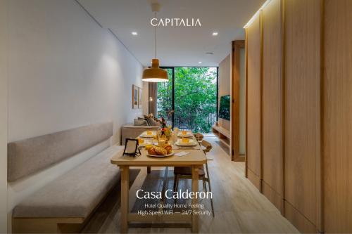 a dining room with a table with food on it at Casa Calderon by Capitalia in Mexico City