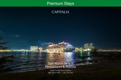 a cruise ship on the water at night at Capitalia Tres Mares Beach Residences & Marina in Puerto Vallarta