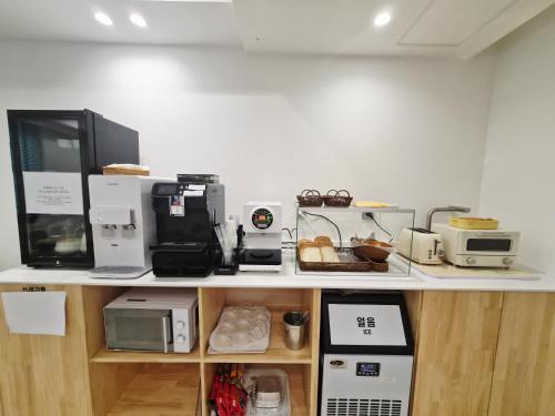 a counter with many different appliances on it at Haeundae HaeRium Hotel in Busan