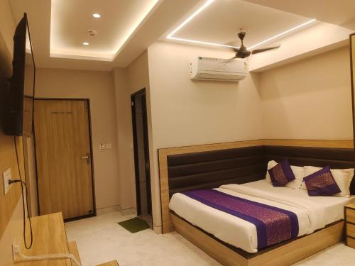 a bedroom with a bed and a ceiling fan at Hotel EURO International - 2 Minute walking New Delhi Railway Station in New Delhi