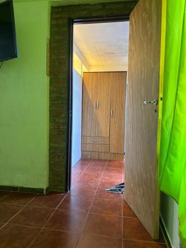 an empty room with green walls and a hallway at B amep in Rawson