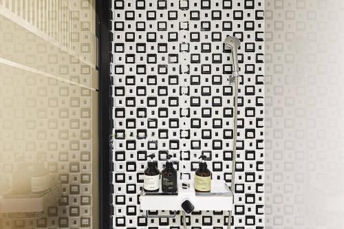 a bathroom with a shower with two bottles on a shelf at Haeundae HaeRium Hotel in Busan