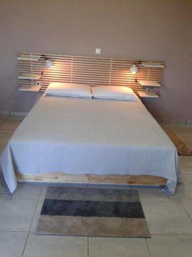 a bedroom with a large white bed with two pillows at Marion Apartments in Kourouta