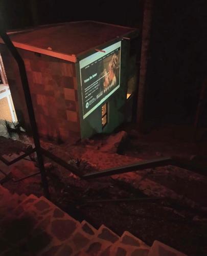 a tv sitting on top of a table in the dark at Glampina in Huixquilucan