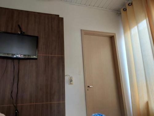 a room with a television on top of a door at Pousada vale das aguas in Foz do Iguaçu