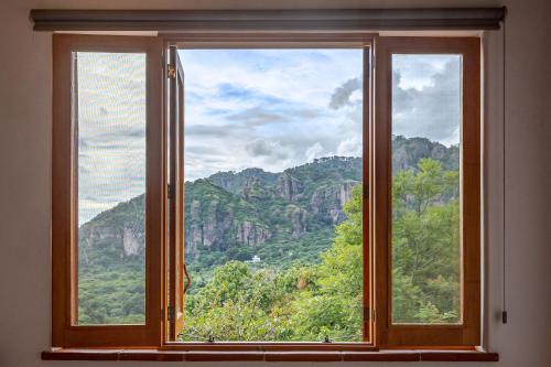 a window with a view of a mountain at Casa Aluna - Oasis in Mountain - Premium 3 bedroom Villa in Tepoztlán with WiFi in Tepoztlán