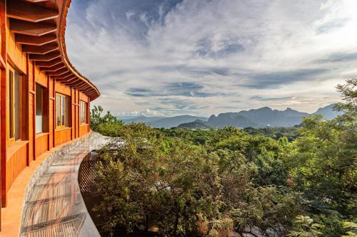 a building with a view of the mountains at Casa Aluna - Oasis in Mountain - Premium 3 bedroom Villa in Tepoztlán with WiFi in Tepoztlán