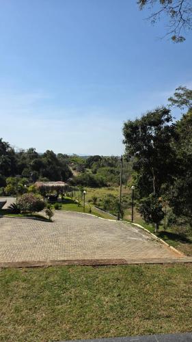 a cobblestone walk way in a park with trees at Ekoa Loft Spa in Piraí